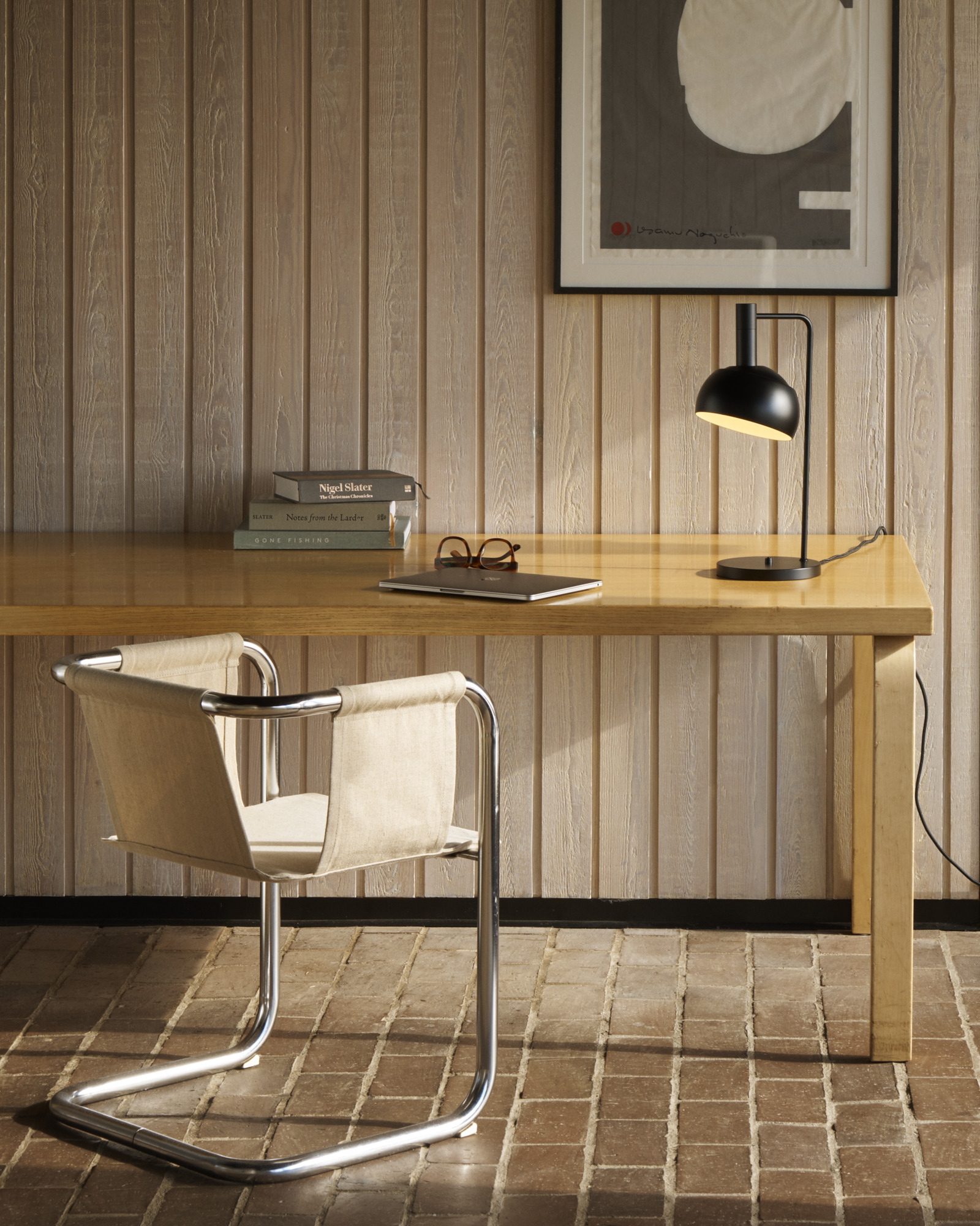 FJ Elements in Black on table in workspace setting, © 2025 Louis Poulsen.