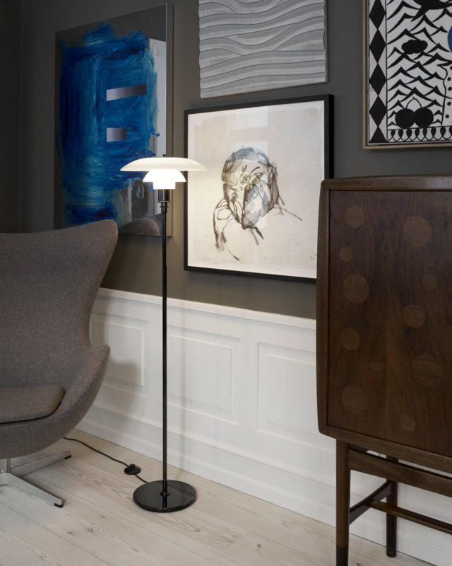 PH Glass Floor Lamp providing soft light beside lounge chair, © 2025 Louis Poulsen.